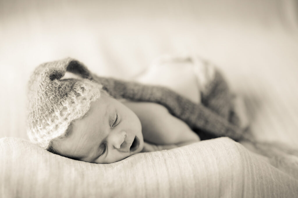 sleeping baby wearing cute hat